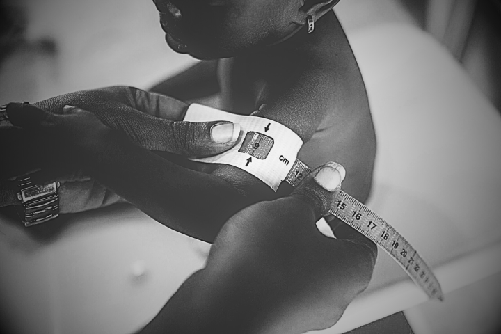 Photo of baby getting measured for size at age