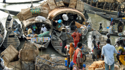 Photo of "transport" canoes being loaded and street vendors in Mopti, Central Mali, Africa