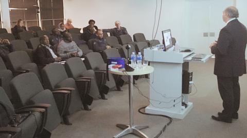 Photo of Prof. Dave Gordon presenting to course participants sitting in a seminar room.