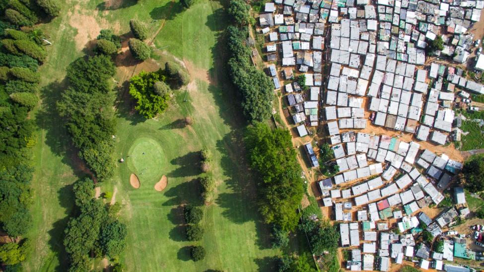 Aerial photo of a golf course adjacent to an informal settlement, Durban, South Africa