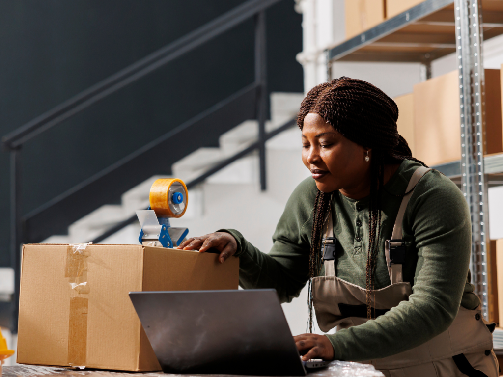 Female warehouse worker analyzing inventory report