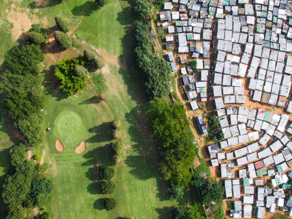 Aerial photo of a golf course adjacent to an informal settlement, Durban, South Africa