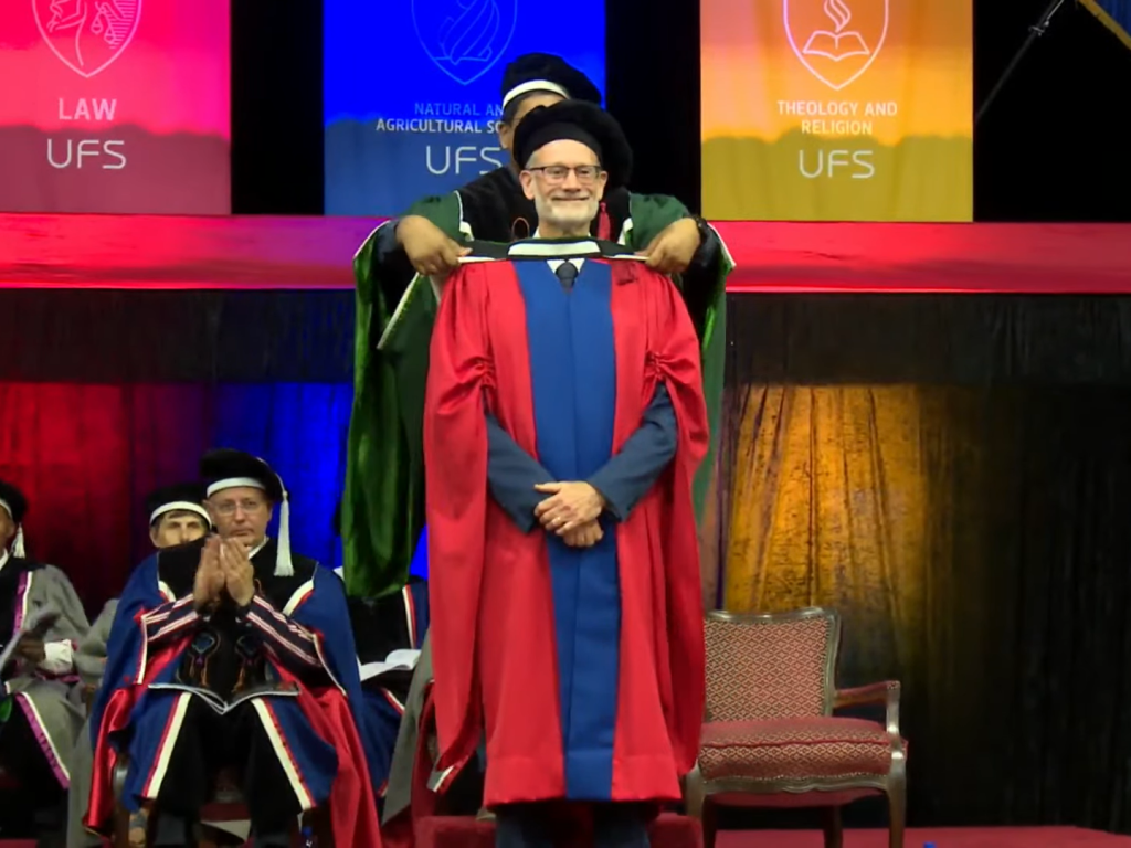 Photo of Prof. Murray Leibbrandt receiving honorary degree from University of Free State