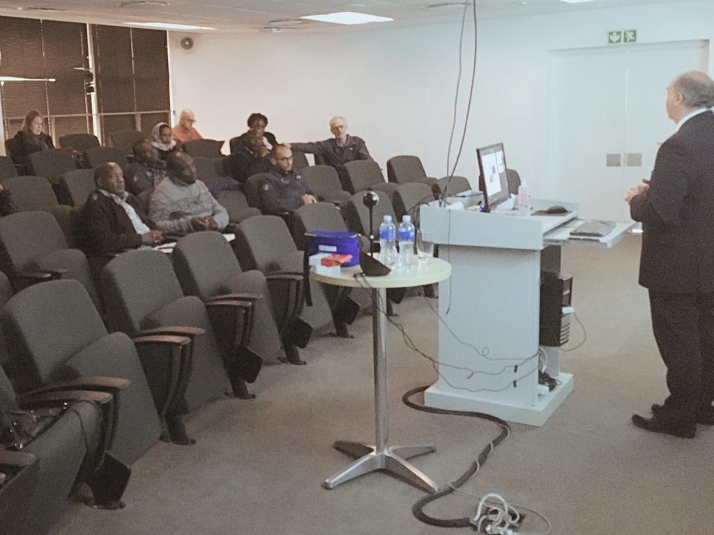 Photo of Prof. Dave Gordon presenting to course participants sitting in a seminar room.